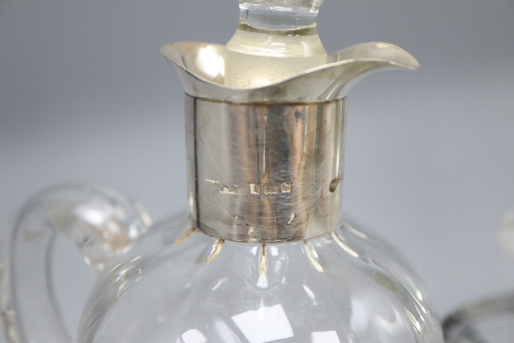 A silver mounted glass claret jug etched Whisky, height 26cm, an Art Deco decanter and another